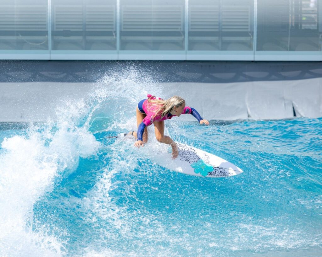 A woman surfing big waves at The Wave Bristol