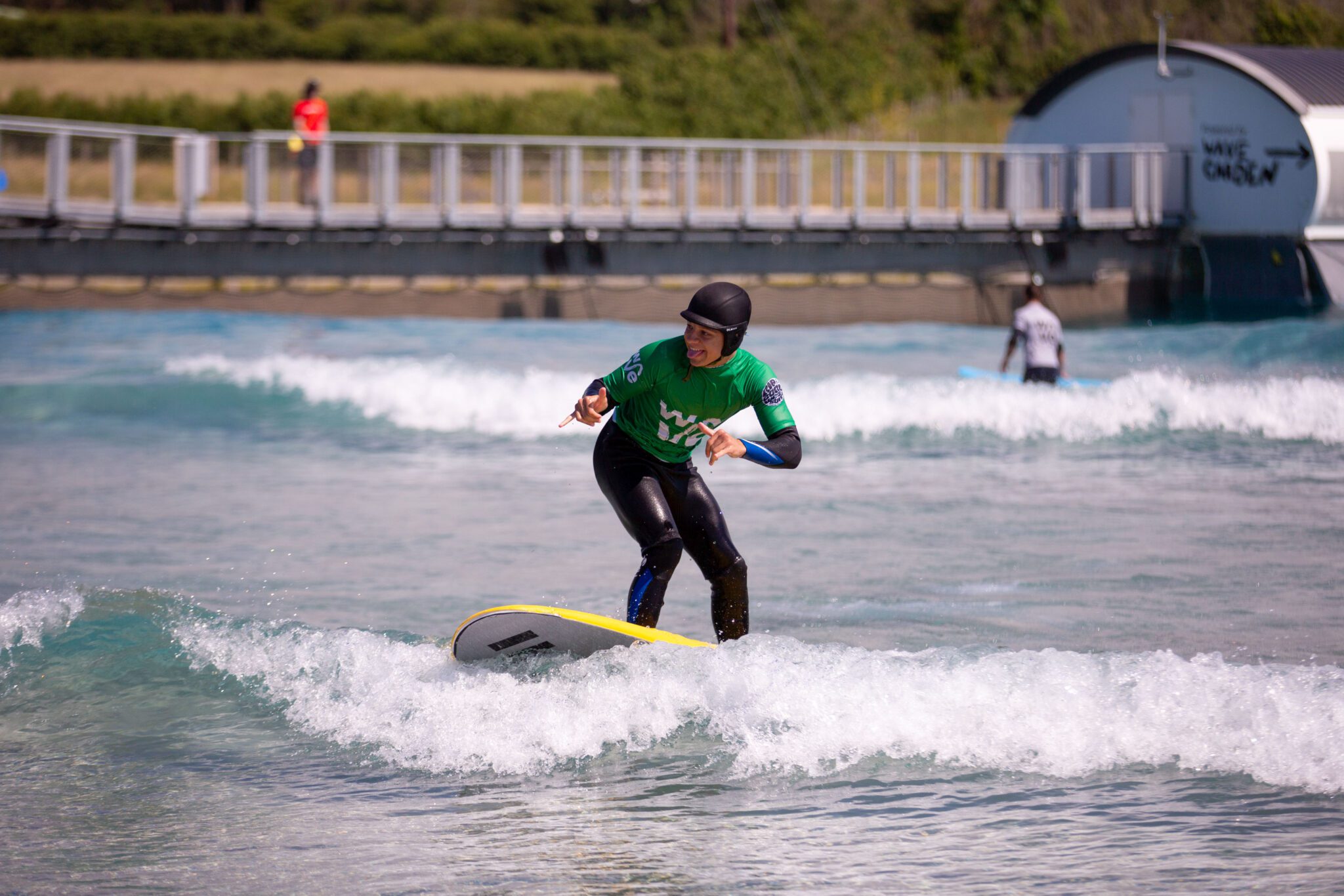 A young man surfs a Beginner wave at The Wave Bristol.