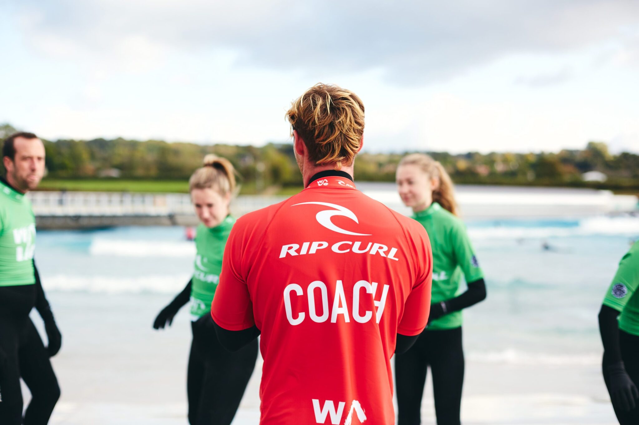 Coach giving instructions before starting the surf class at The Wave near Bristol
